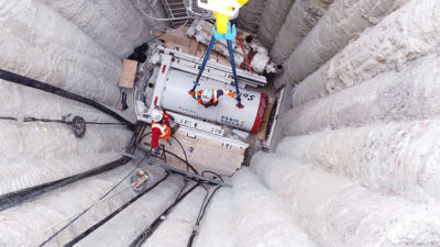 Installation du microtunnelier - Descente dans le puit d'entrée à l'aide d'une grue.